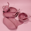 Lulushop 6-piece baby feeding set in Pink Daisy, featuring silicone suction plate, bowl, bib, cup, and utensils.