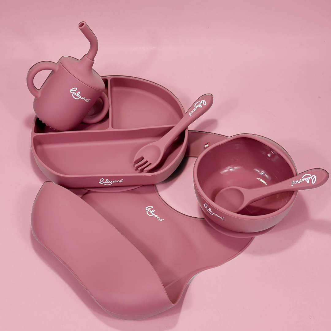 Lulushop 6-piece baby feeding set in Pink Daisy, featuring silicone suction plate, bowl, bib, cup, and utensils.