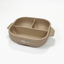Light apricot square silicone baby plate viewed from a front-top angle
